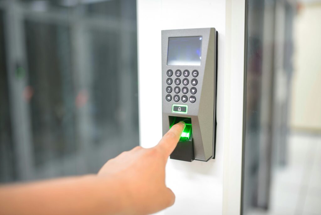Finger pressing fingerprint sensor on smart door lock for keyless entry